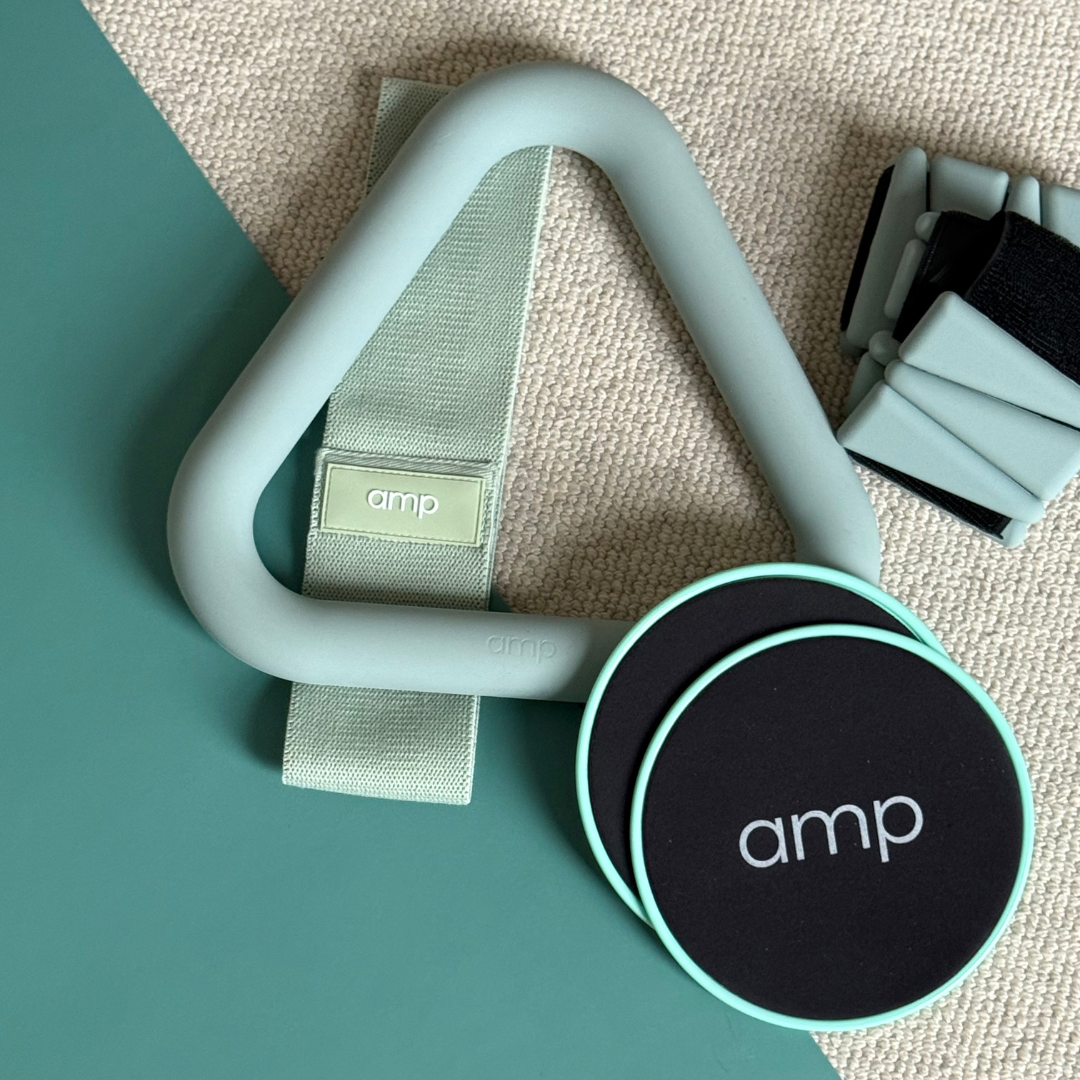 home workout weights and accessories laid out on a green yoga mat