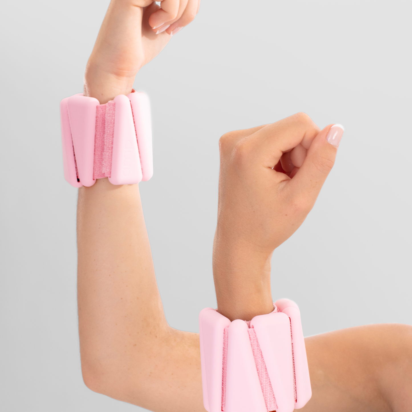 pink ankle wrist weights home and studio fitness women in raised arm exercise pose
