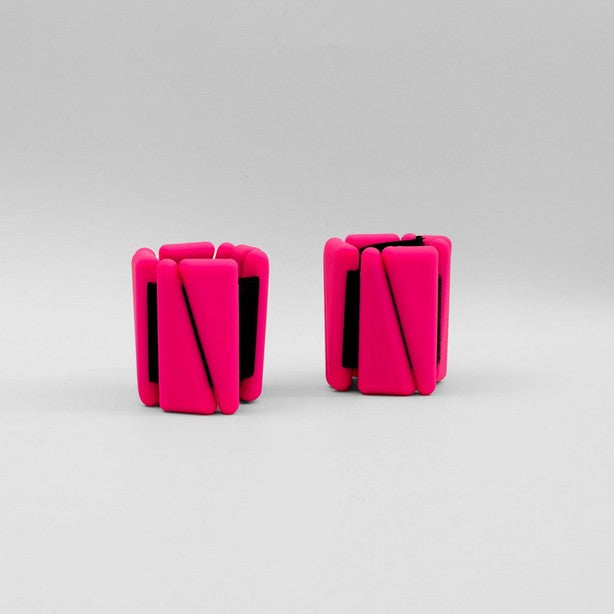 A pair of neon pink adjustable ankle wrist weights