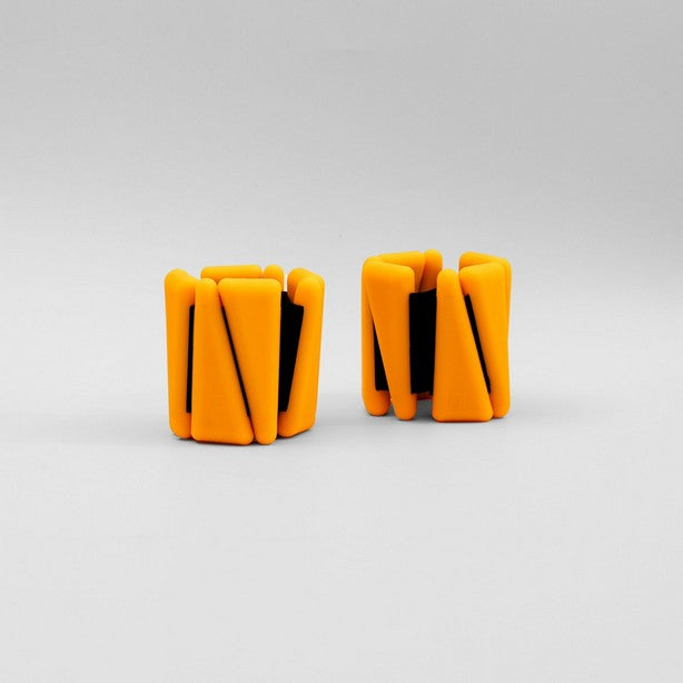 A pair of neon orange adjustable ankle wrist weights