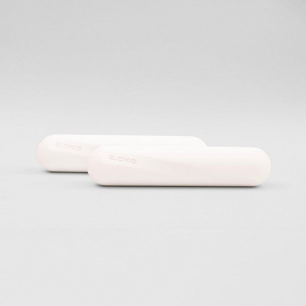 A pair of white dumbbell strength bars, each weighing 2kg, placed side by side against a neutral background.