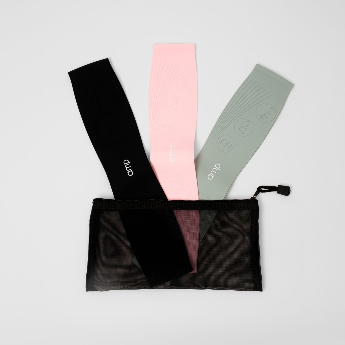 Three resistance bands in black, pink, and sage green with a carrying case on a light gray background.