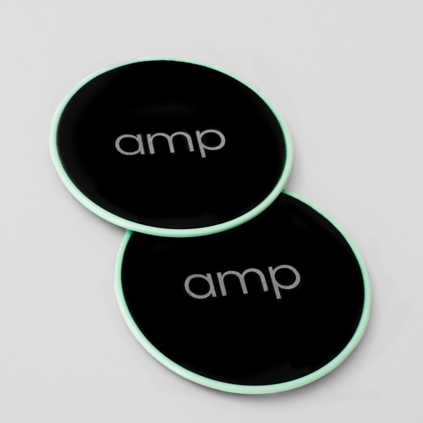 Two green sliders core discs with 'amp' logo on a light gray background