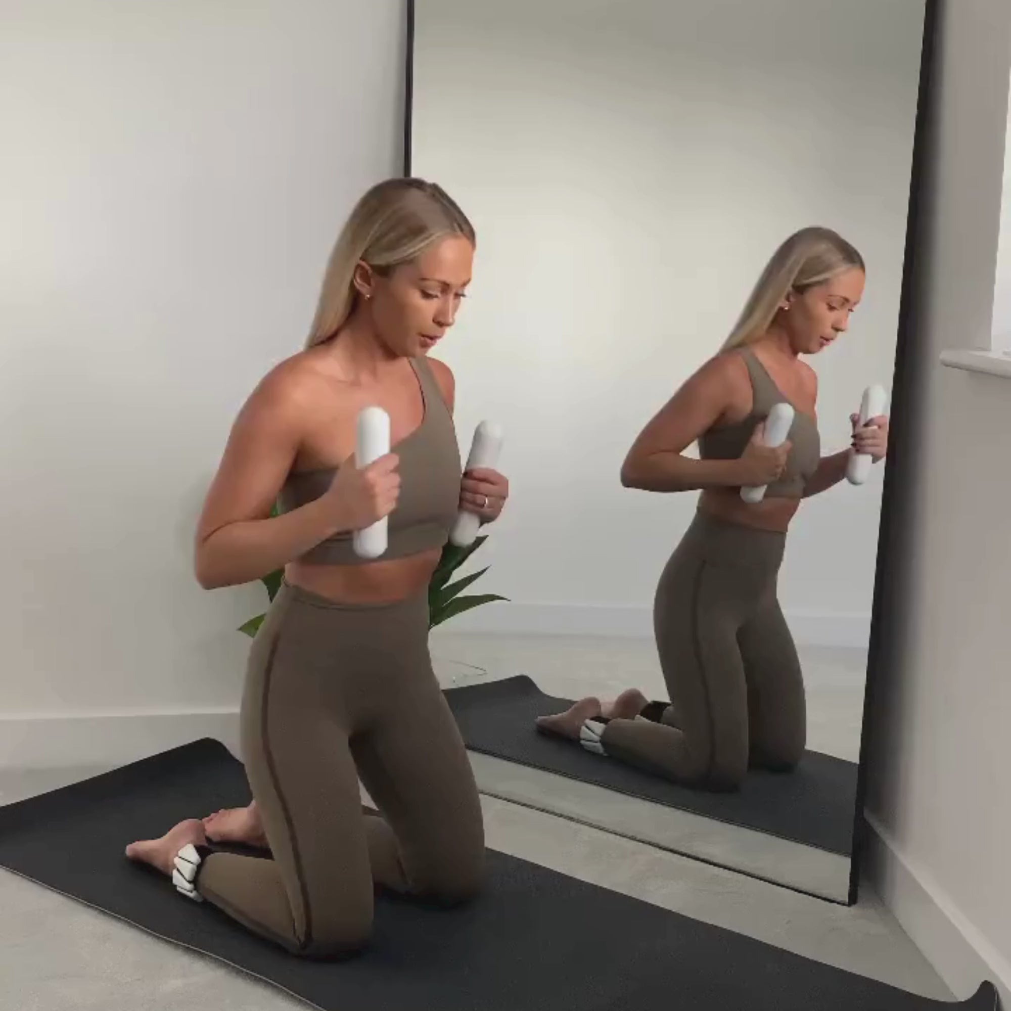 Instructor demonstrating 4kg dumbbells pair 2kg bar Pilates barre workout amp wellbeing